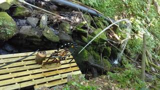 Water flowing from the hose to power the project